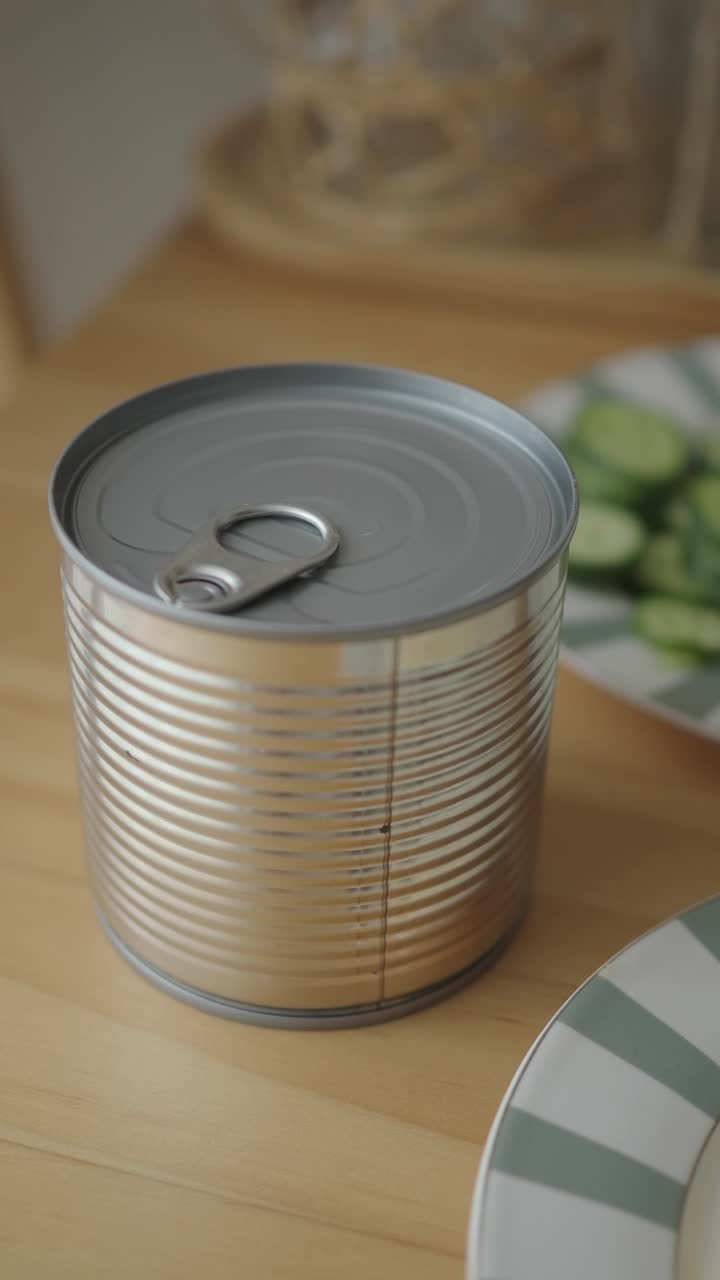 Closed Tin Can with Pull Tab on a Wooden Table