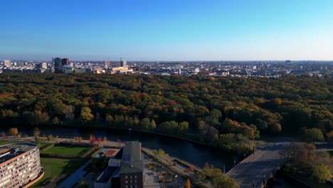 schloss bellevue palace nestled among vibrant autumn foliage in tiergarten park, berlin, germany. nice aerial view flight rotation to left drone