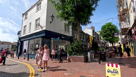 people walking on a sunny brighton street