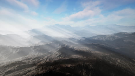 majestic mountain range with fog and sunbeams