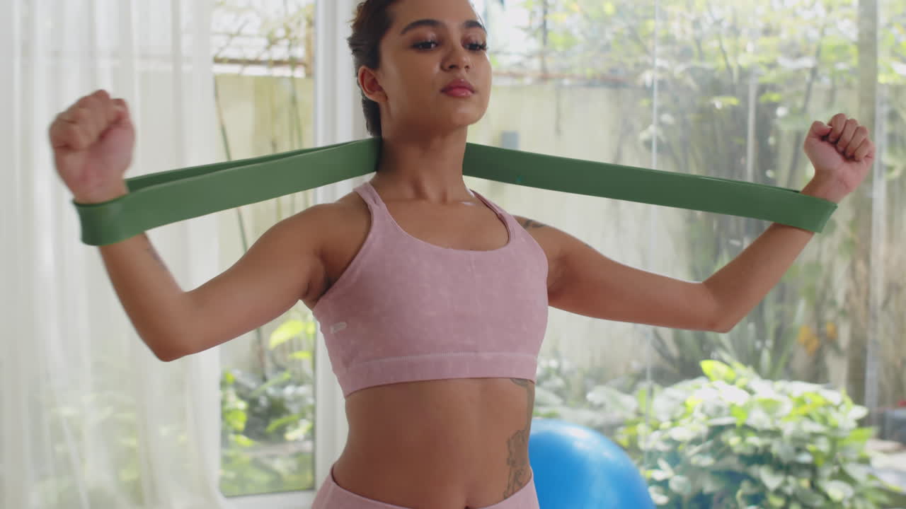 Sportswoman Doing Exercises with Resistance Bend