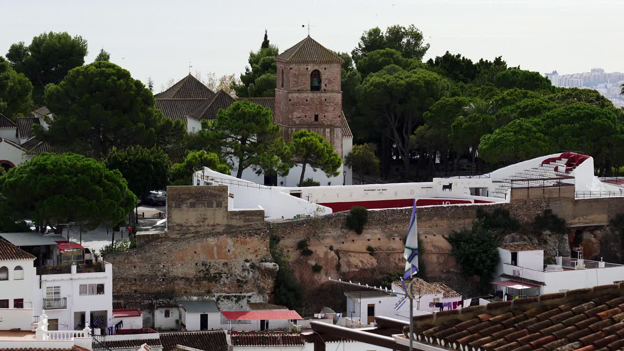 Zoomed in shot of the church tower of Mijas and the historic bull fighting ring of this old white town. Costa del Sol, Spain
