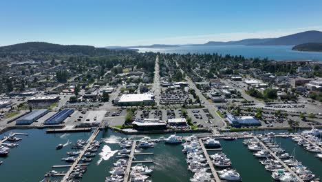 aerial shot pushing forward over the anacortes marina and into the downtown strip