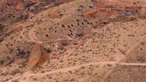 Tilt-up-reveal-of-historic-mining-town-Jerome,-Arizona-from-high-desert-country-in-the-southwestern-US