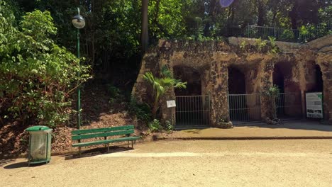 a serene park area with a stone tunnel