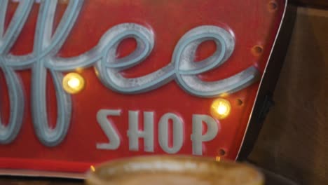 yellow coffee cup and vintage signage in a cafe - close up shot