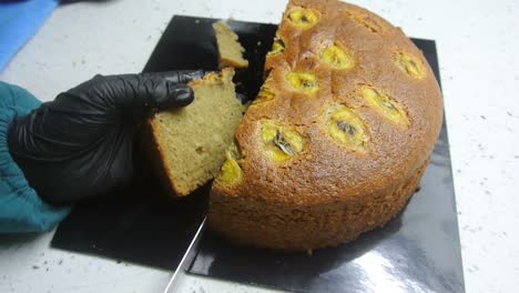freshly baked cakes are carefully cut to get the same cut size. it is cut using a long cutting knife