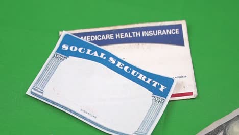 money placed around a social security card and medicare card to show retirement funds and health care benefits