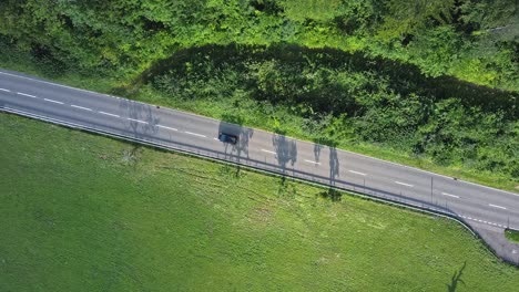 a shot from above a street where a car drives by