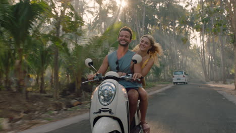 travel couple riding motorcycle on tropical island exploring beautiful travel destination having fun ride on scooter