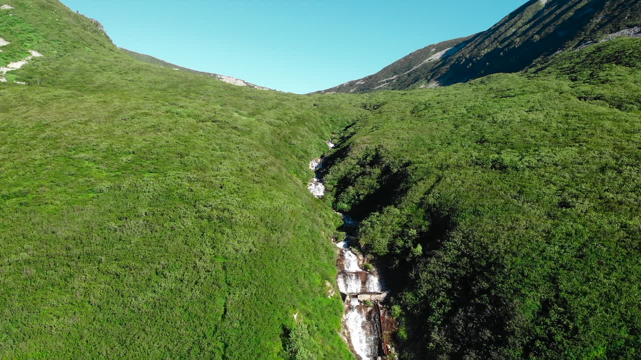 Scenic Waterfall in a Green Mountain Valley