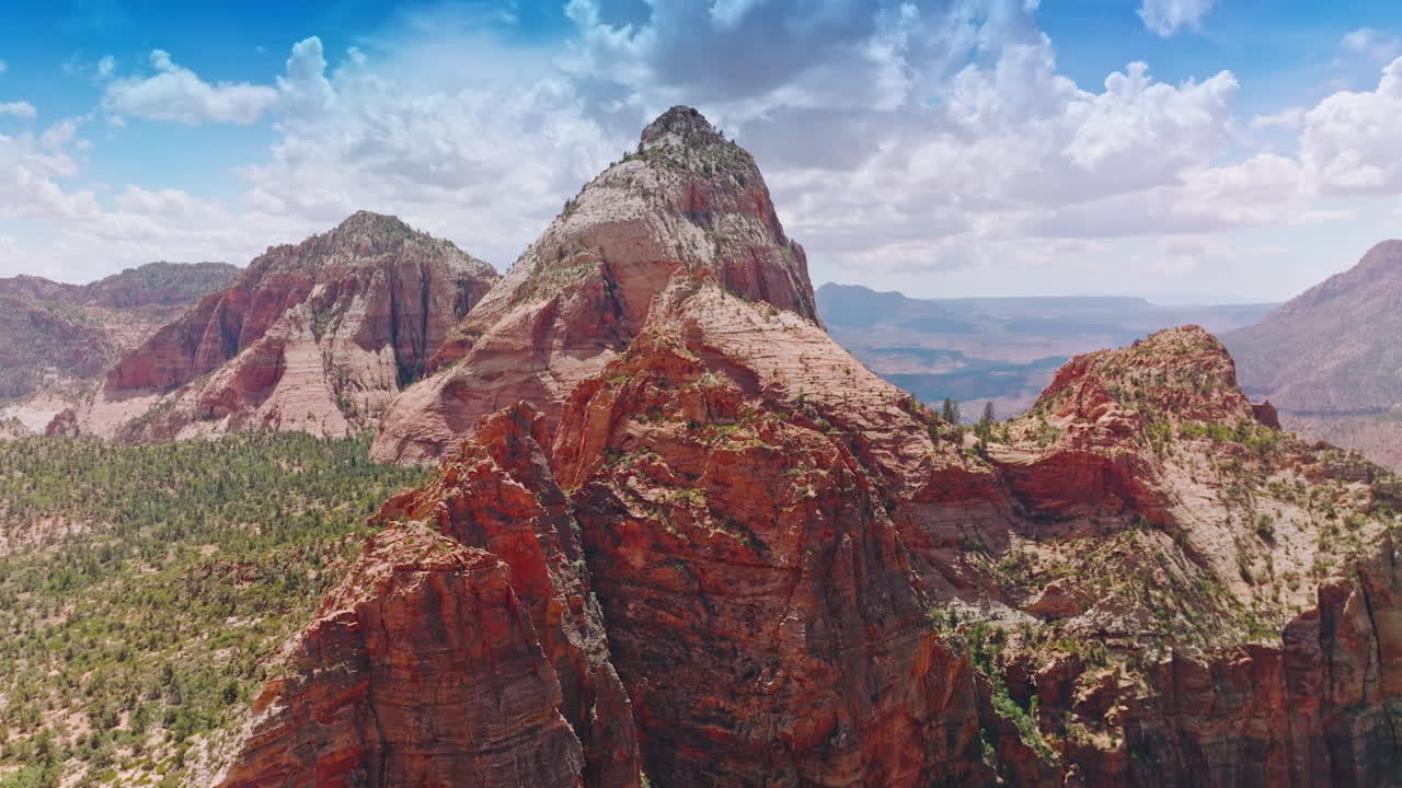 Pointed tops of mountains in the light of bright sunshine. Canyons of Zion National Park in Utah, USA from aerial perspective.