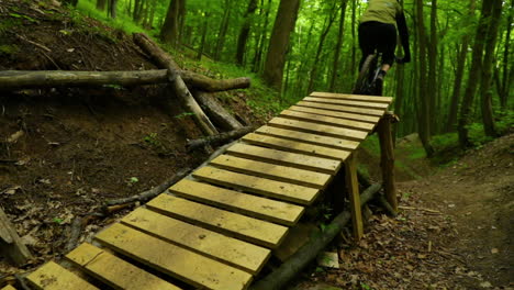 close-up view of a wooden jumper and mountain bike during a flight