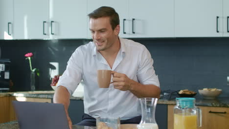 smiling man drinking coffee during skype call. closeup man having online chat.