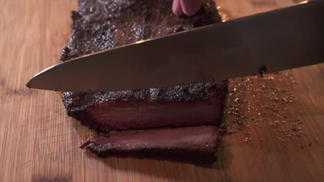 slicing a juicy piece of smoked flat cut beef brisket