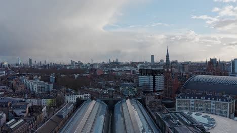 slow drone shot looking south from kings cross train station roof london