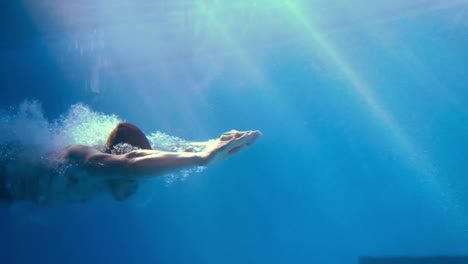 handsome man swimming underwater