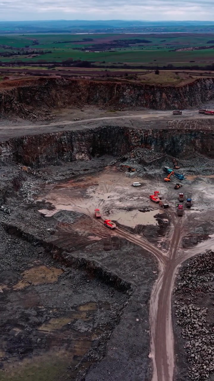 Aerial View of Heavy Machinery Operating in an Open Pit Stone Quarry