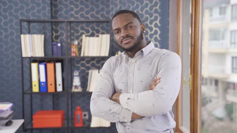 African-employee-looking-at-camera-in-office.-Positive-facial-expression.