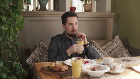 man enjoying breakfast at a cafe