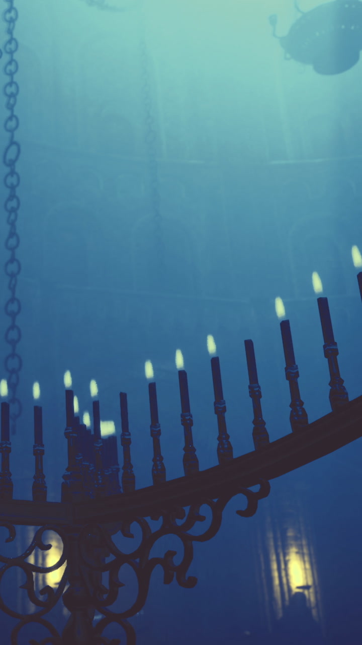 Chandelier with lit candles inside a dimly lit location at night