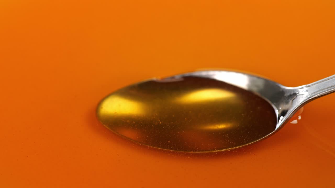 Taking Honey By Metal Spoon. Healthy Organic Thick Honey Closeup, Sweet Honey Dessert 4K. Slow Motion