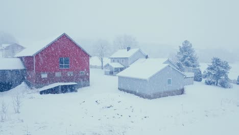 heavy snow fall in a village in norway - drone shot
