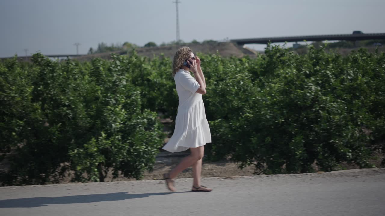Woman Walking in Orange Orchard