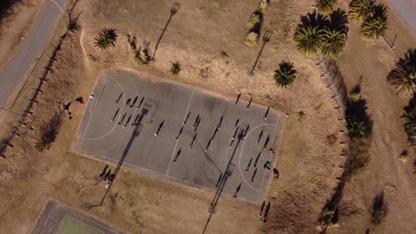 people practicing handball outdoors. aerial top down view