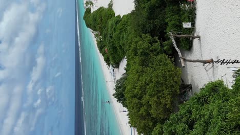 perfect tropical island paradise on dhigurah island sandbank with its volleyball court on long white sand beach amid pristine turquoise water and lush vegetation