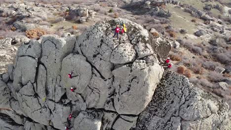 rock climbers climbing a big vertical rock