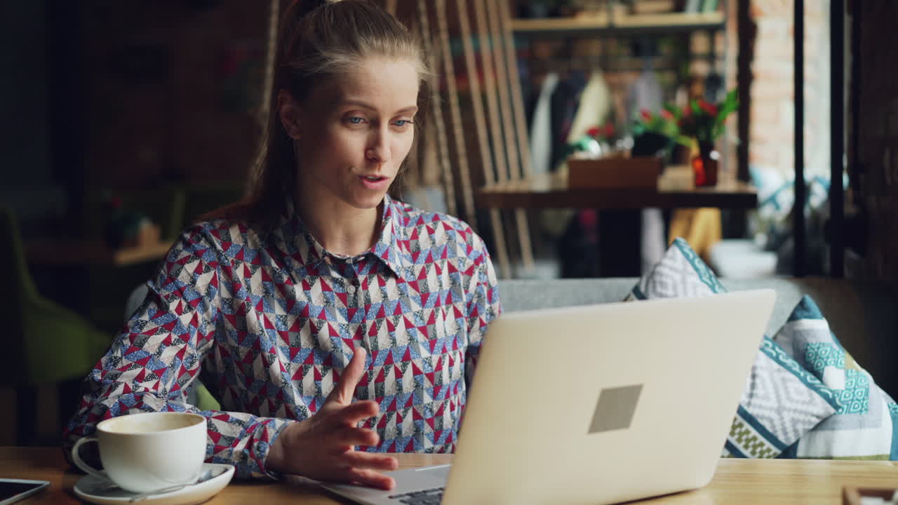 Woman in a cafe having a video call