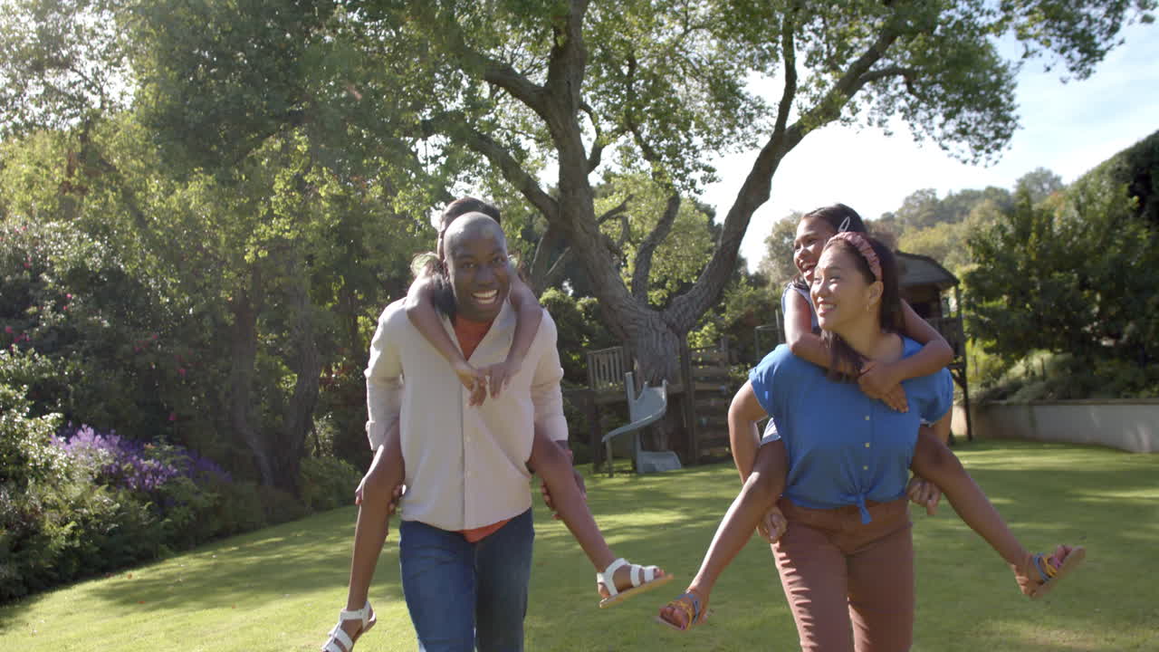 Walking in backyard, family of four enjoying quality time together
