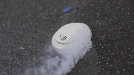 smoke detector burning up and smoking dramatic irony in slow motion