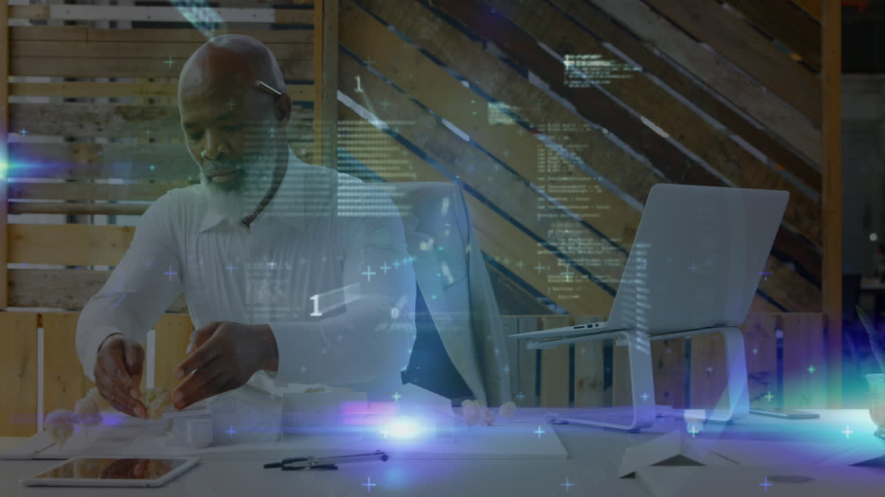 Animation of financial data processing over african american engineer working on his model at office