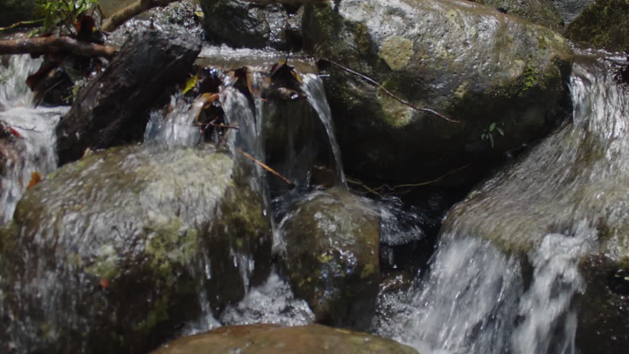 A little stream makes its way bubbling through the rocks towards a giant 80 meter high waterfall 