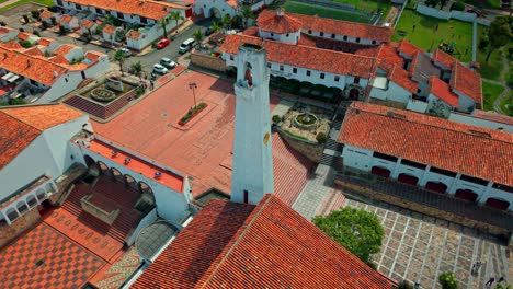 aerial orbit establishing the church and main square of the tourist town of guatavita, colombia near bogota on a sunny day.