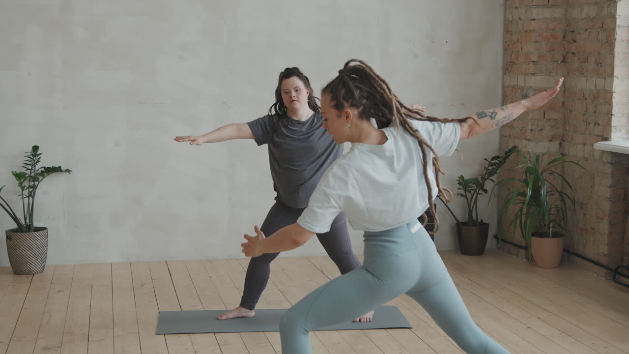 Young Woman With Down Syndrome Practicing Yoga With Trainer