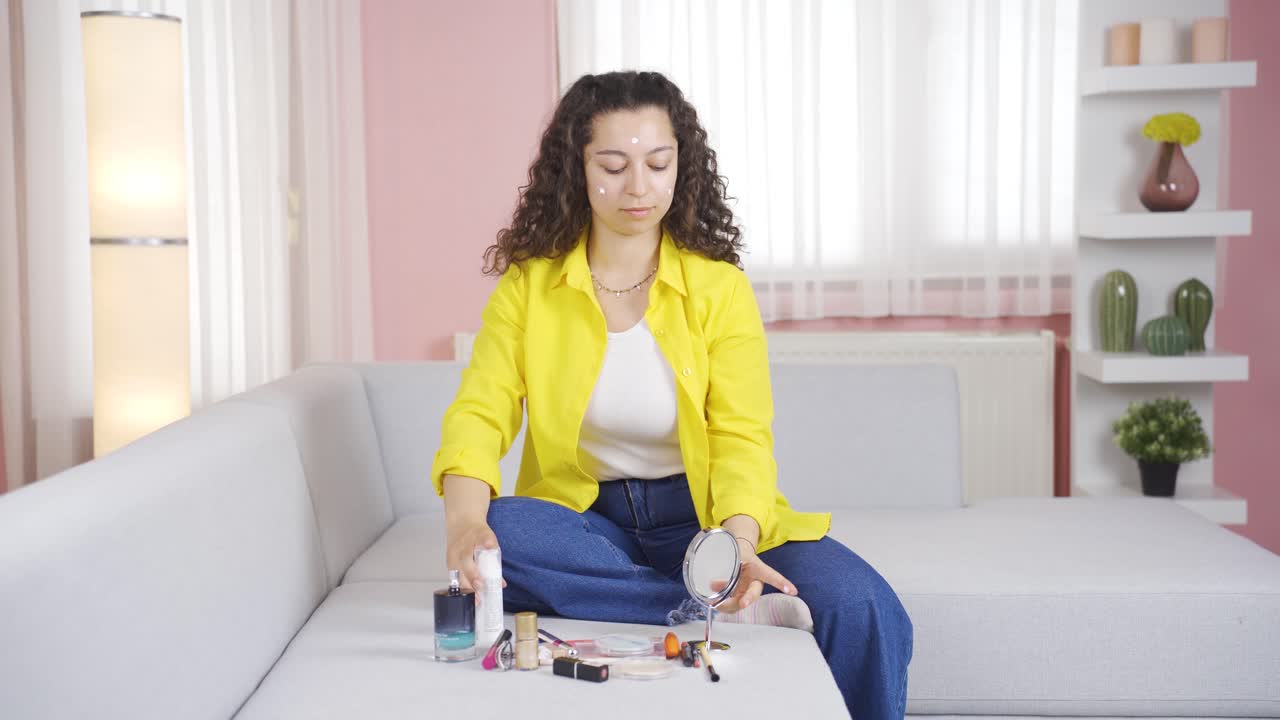 The young woman who puts cream on her face. Skin beauty.