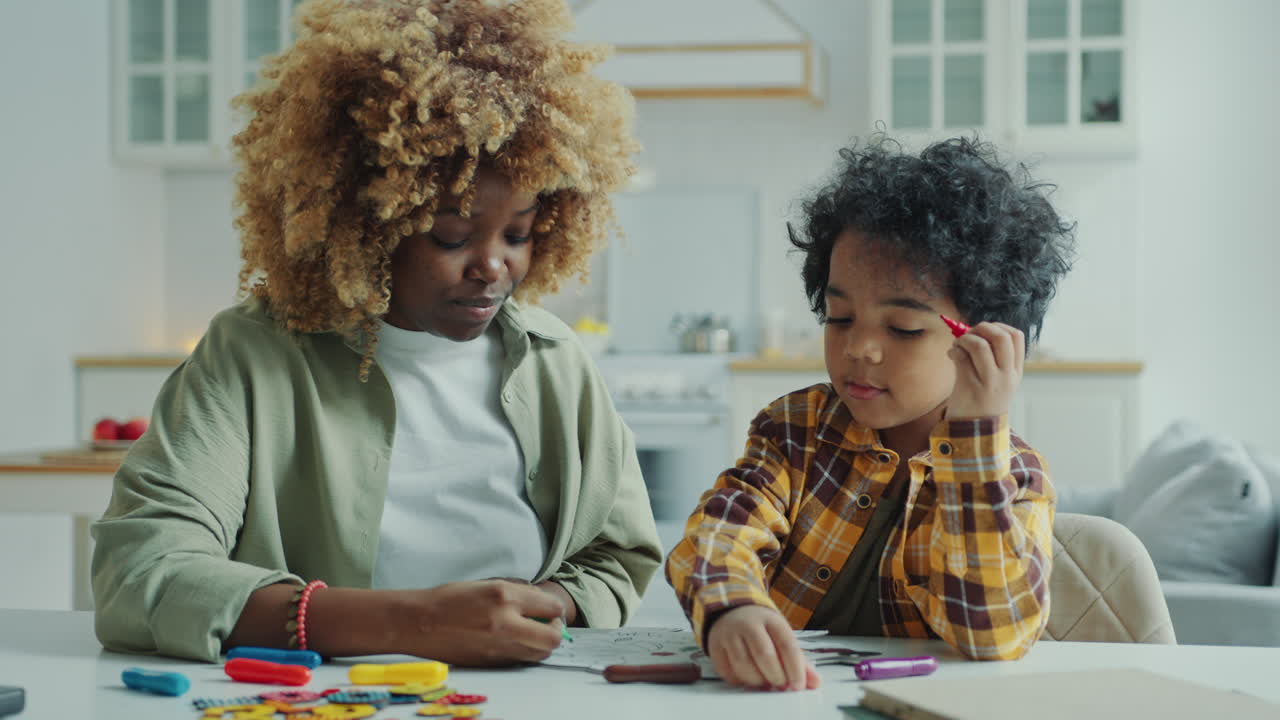 Preschool Kid and His Mother Drawing Together on Paper at Home