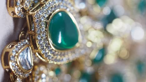 close-up of gold and emerald jewelry