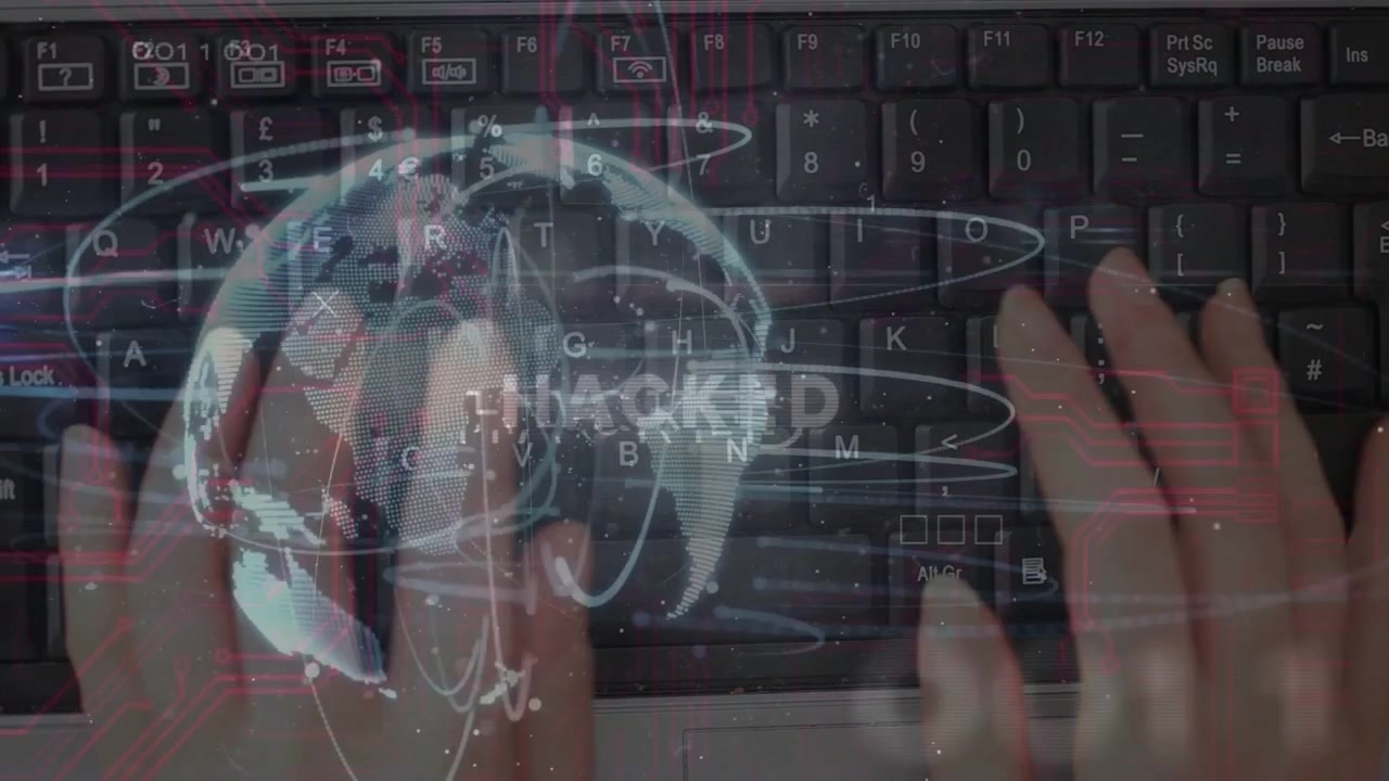 Hands landing on keys typing while globe appearing rings orbiting HACKED flashing signaling breach