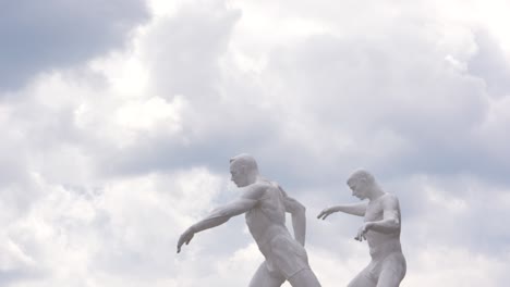 statues of running soccer players