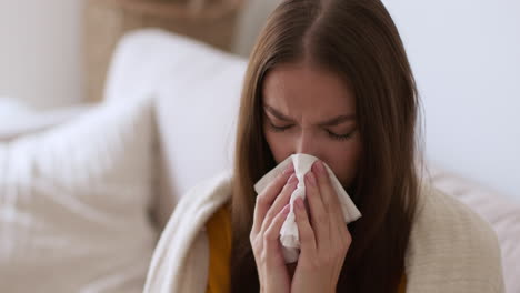 woman blowing nose