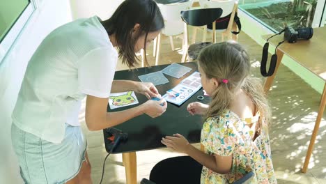 mother and daughter doing a craft activity together