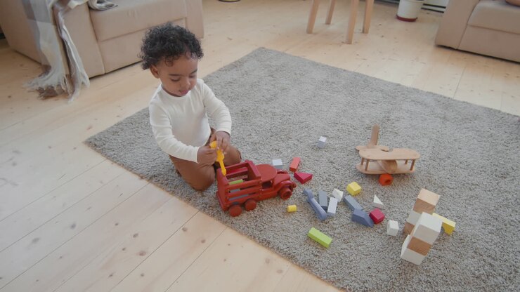 Cute Baby Boy Playing with Toys on Floor