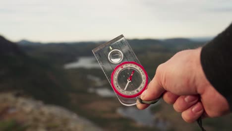 hiker holding a compass to find direction