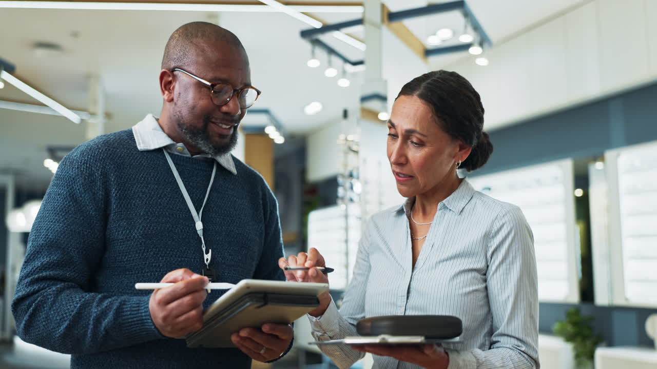 Optometrist talking to a customer about eyeglasses