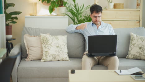 sad businessman while working on laptop at home