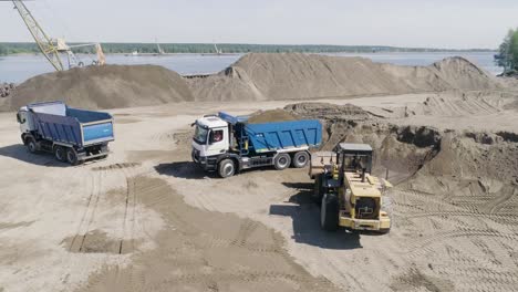 construction site with dump trucks and excavator